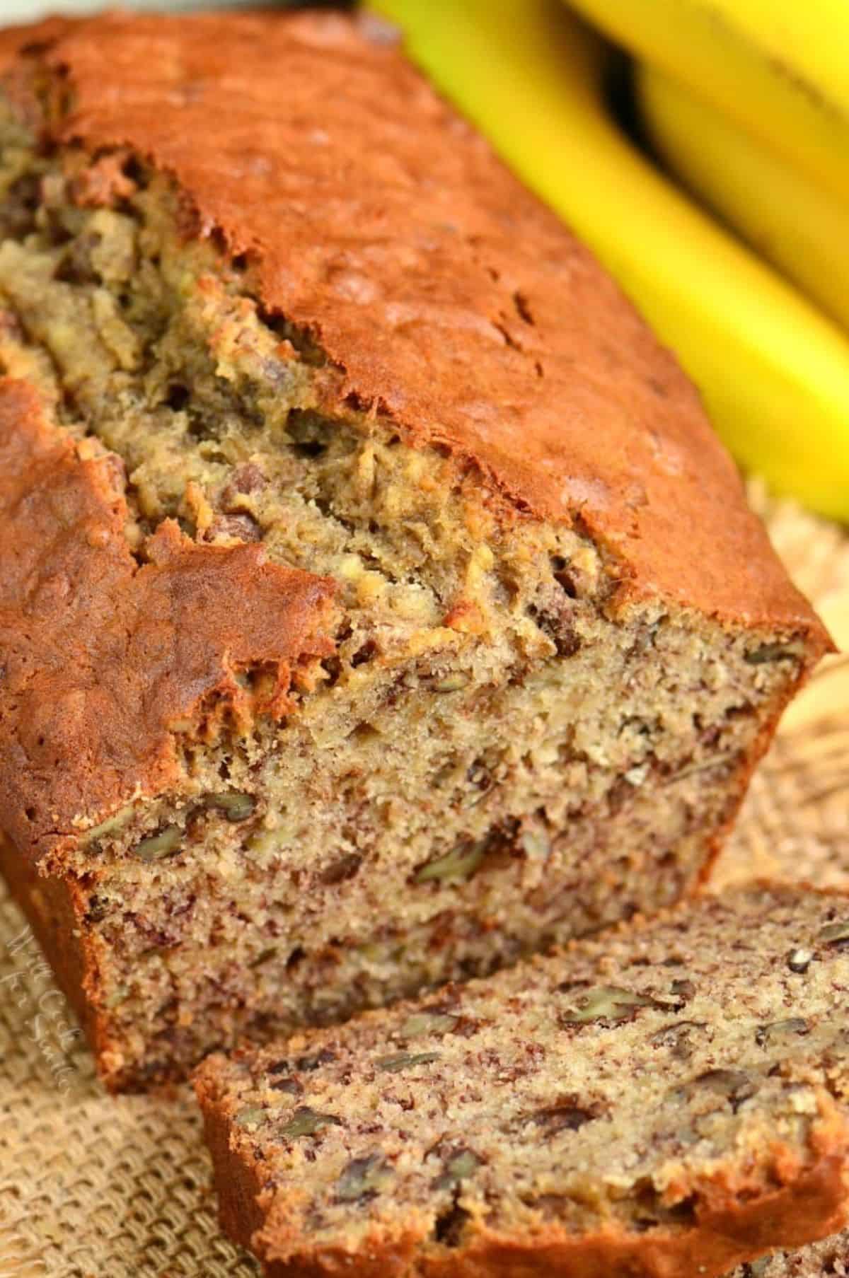 One slice of banana bread has been removed from the end of a loaf. 