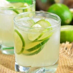 caipirinha in a short glass with ice and lemons.