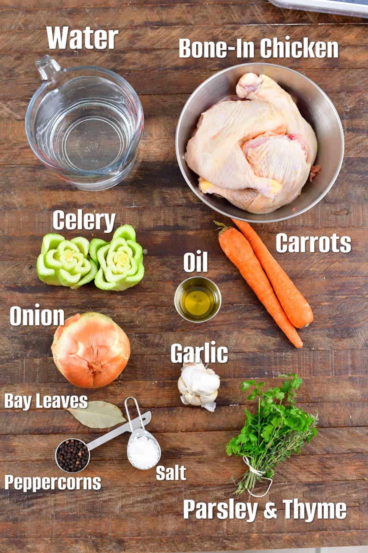 labeled ingredients for chicken stock on a wood surface.