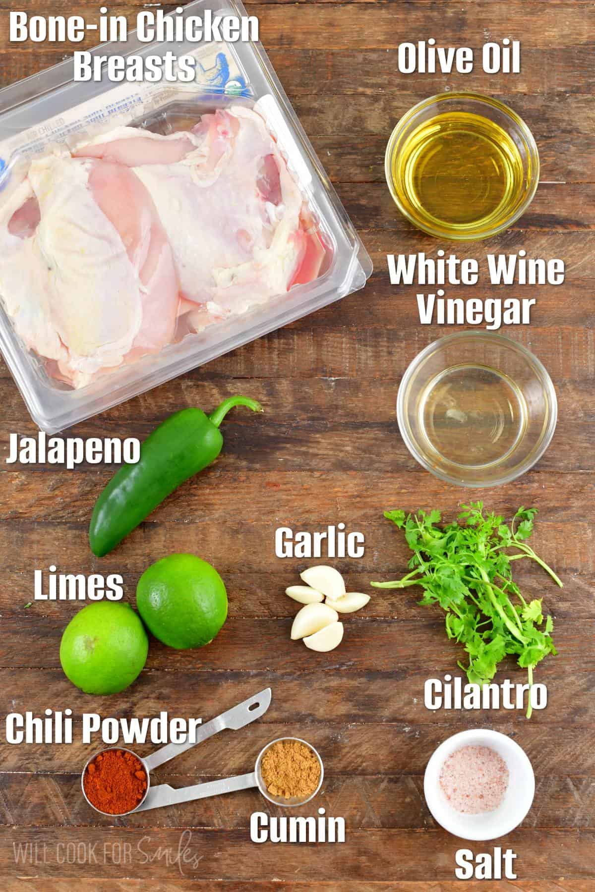 The ingredients for chili lime chicken are placed on a wooden surface. 