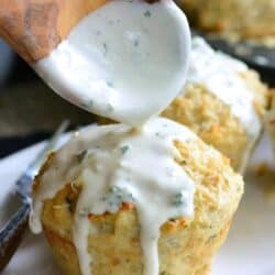 two chicken meatloaves with one getting sauce from a wooden spoon poured over it.