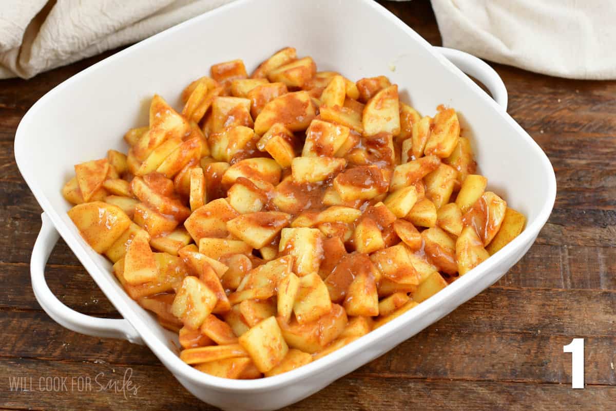 Diced apples with brown sugar and cinnamon in a casserole dish.