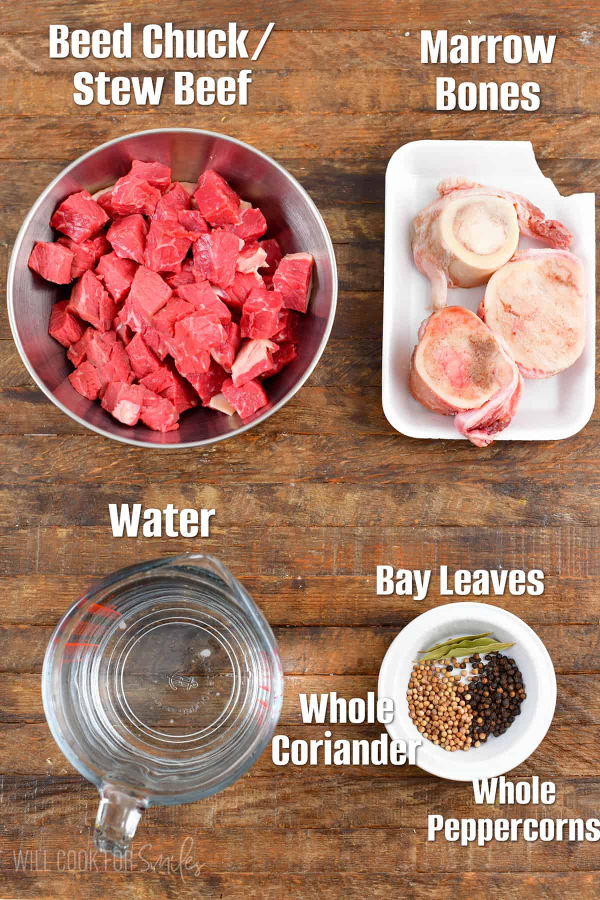 Labeled Ingredients for borscht broth on a wood surface.