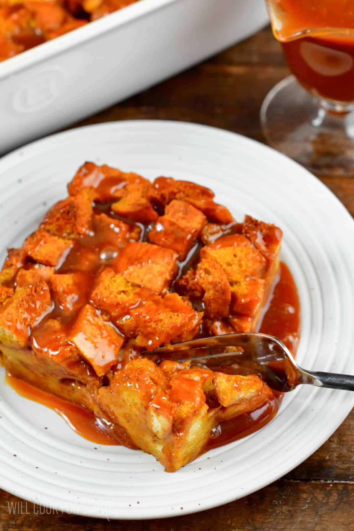 pumpkin bread pudding with a fork cutting through a piece.