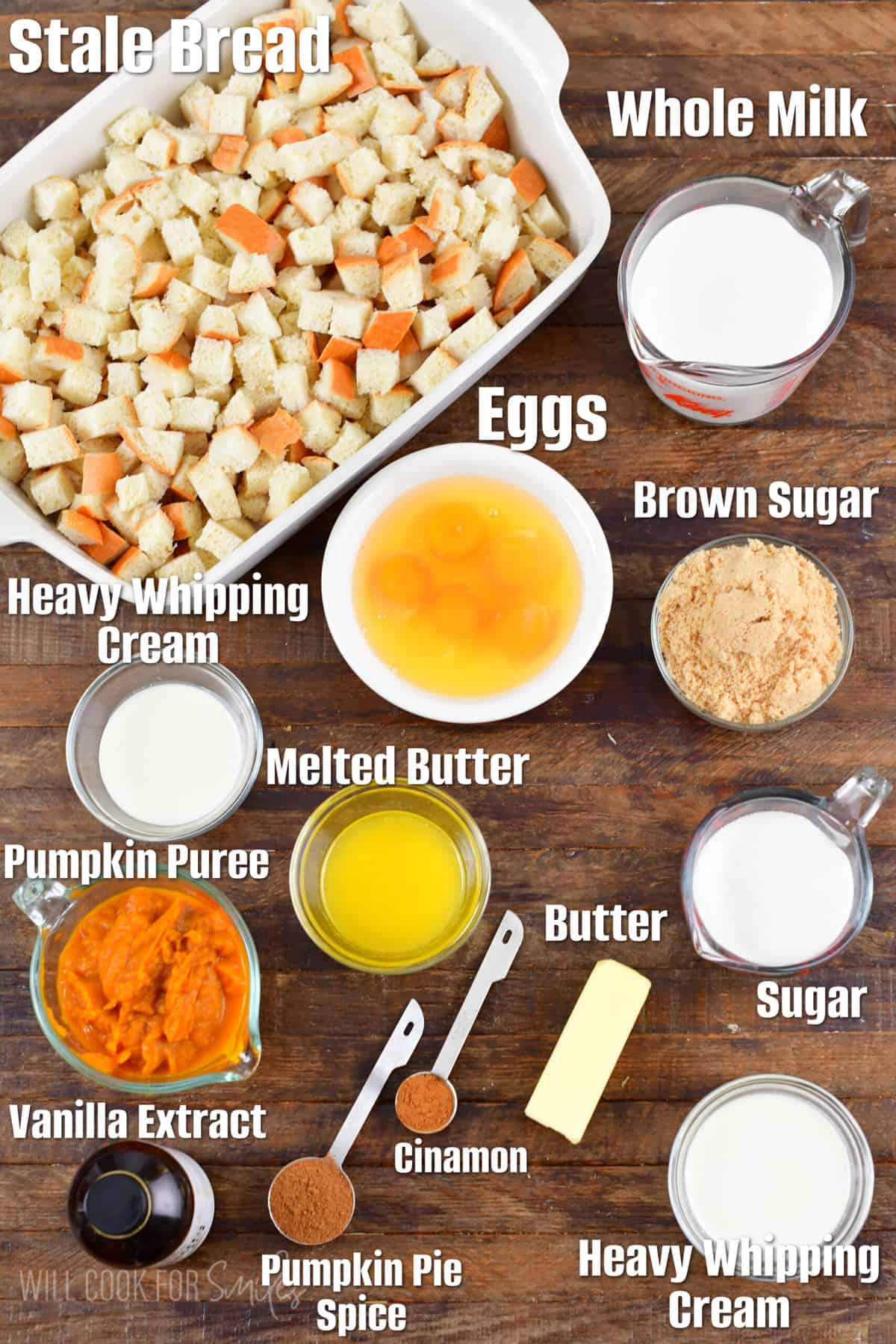 Labeled ingredients for pumpkin bread pudding on a wood surface.