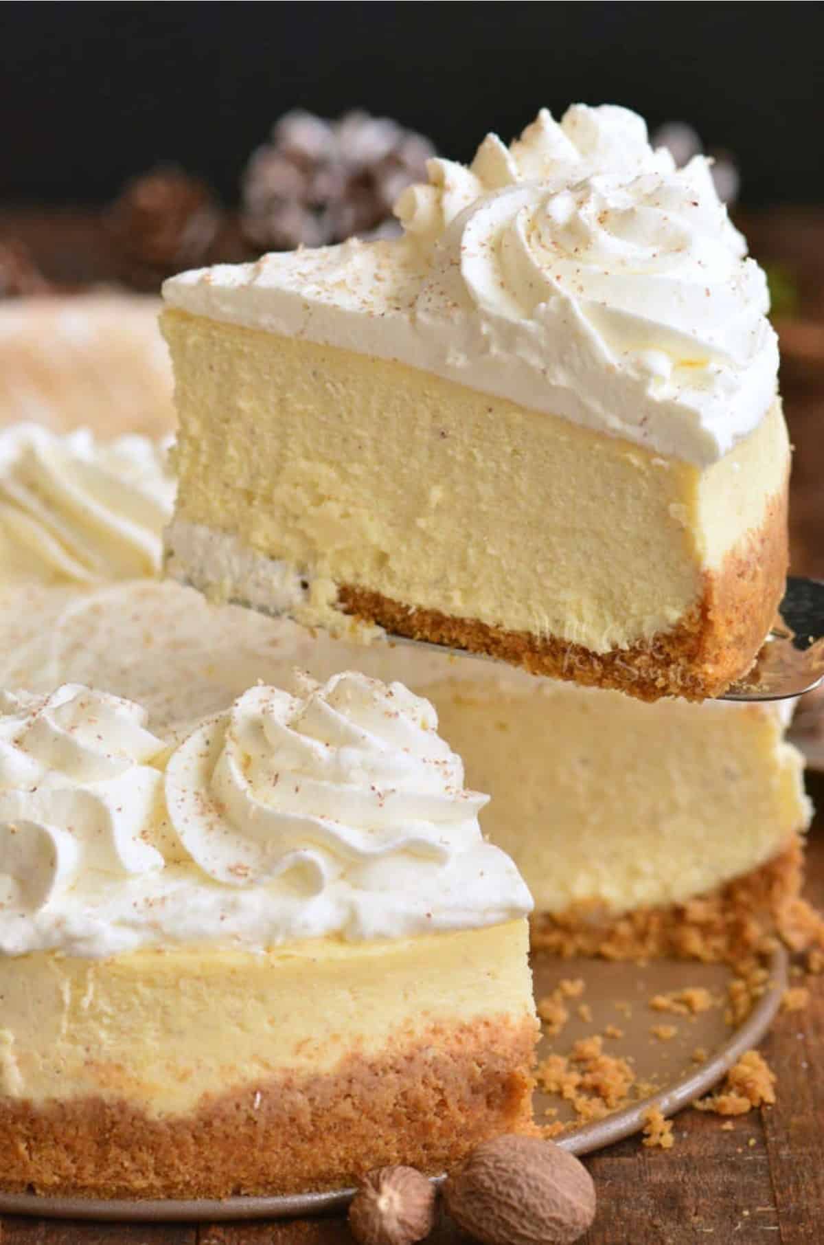 eggnog cheesecake with a slice being pulled out.