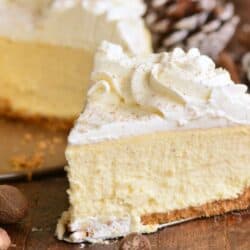 slice of eggnog cheesecake on a wood surface.