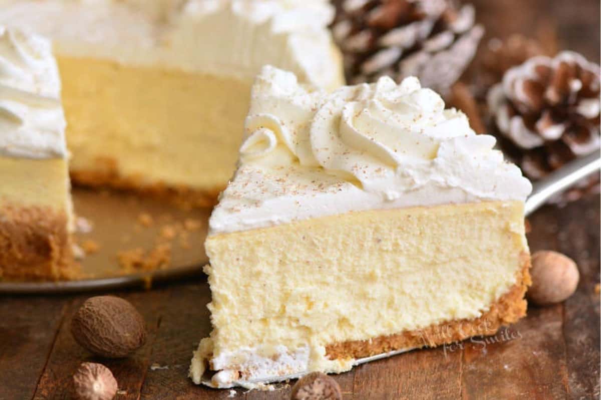 slice of eggnog cheesecake on a wood surface.