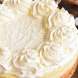 Eggnog Cheesecake with topping on a wood surface.