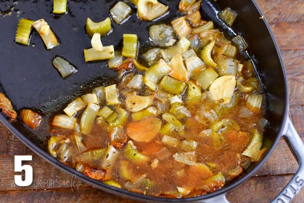 leftover pan drippings and veggies in the roasting pan.