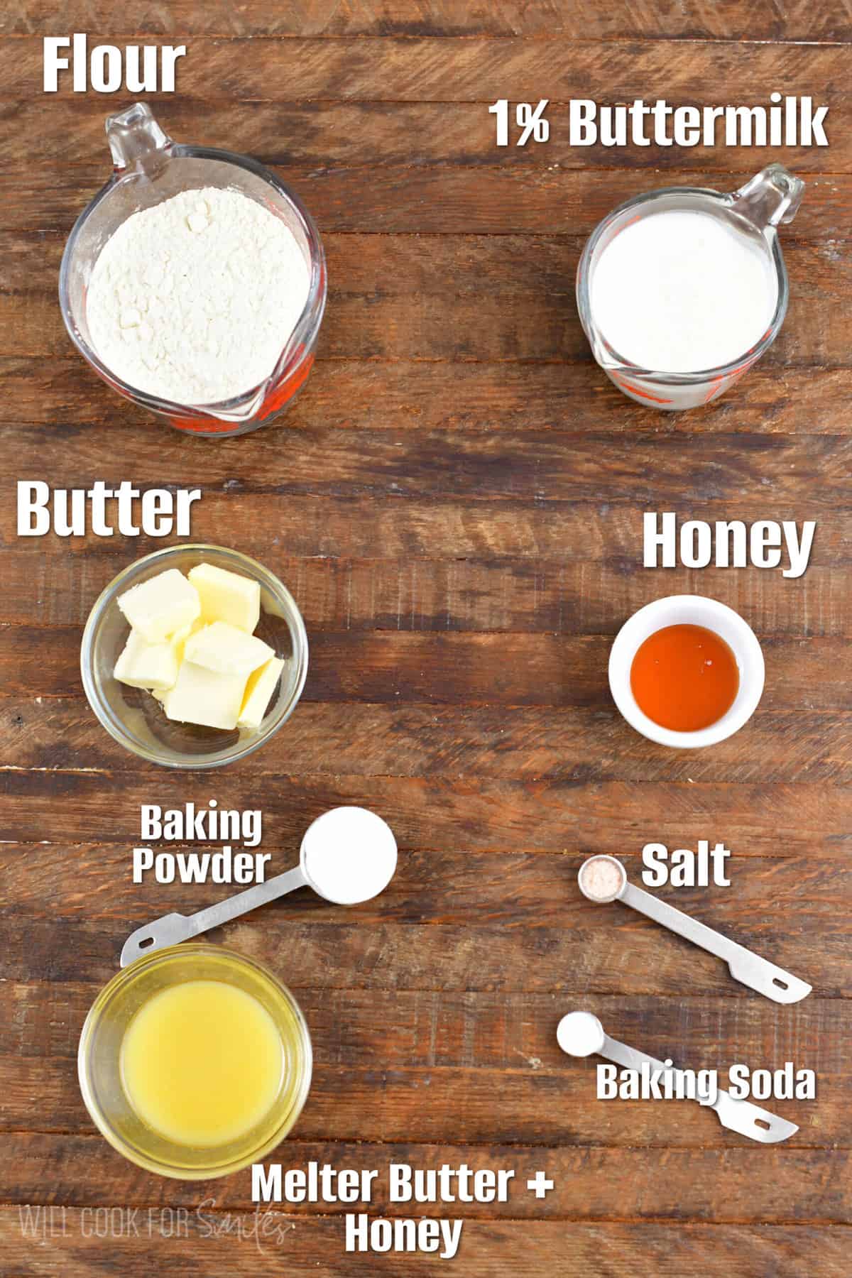 labeled ingredients for honey butter biscuits on a wood surface.