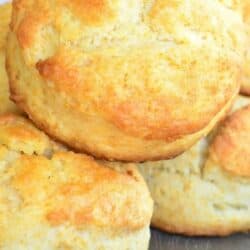 honey butter biscuits stacked on a baking sheet.