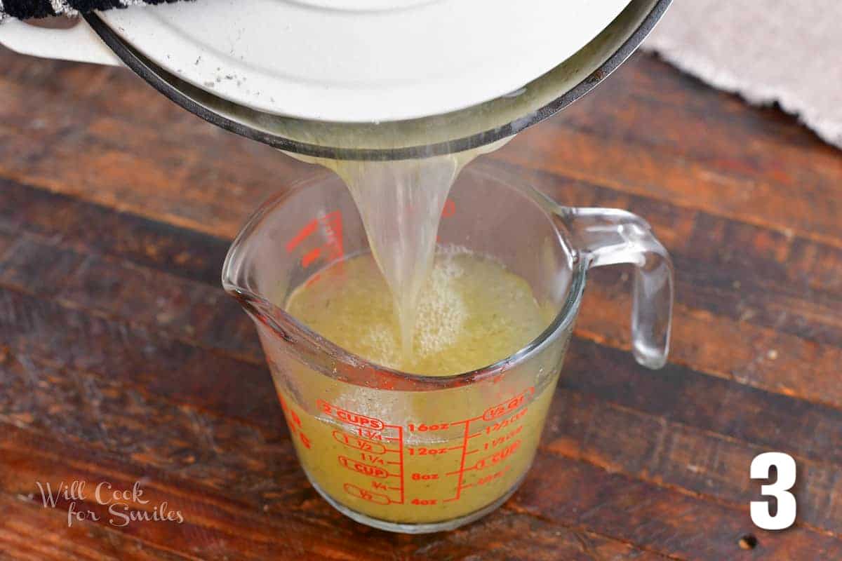 pouring off cooking water from a pot into a measuring glass.