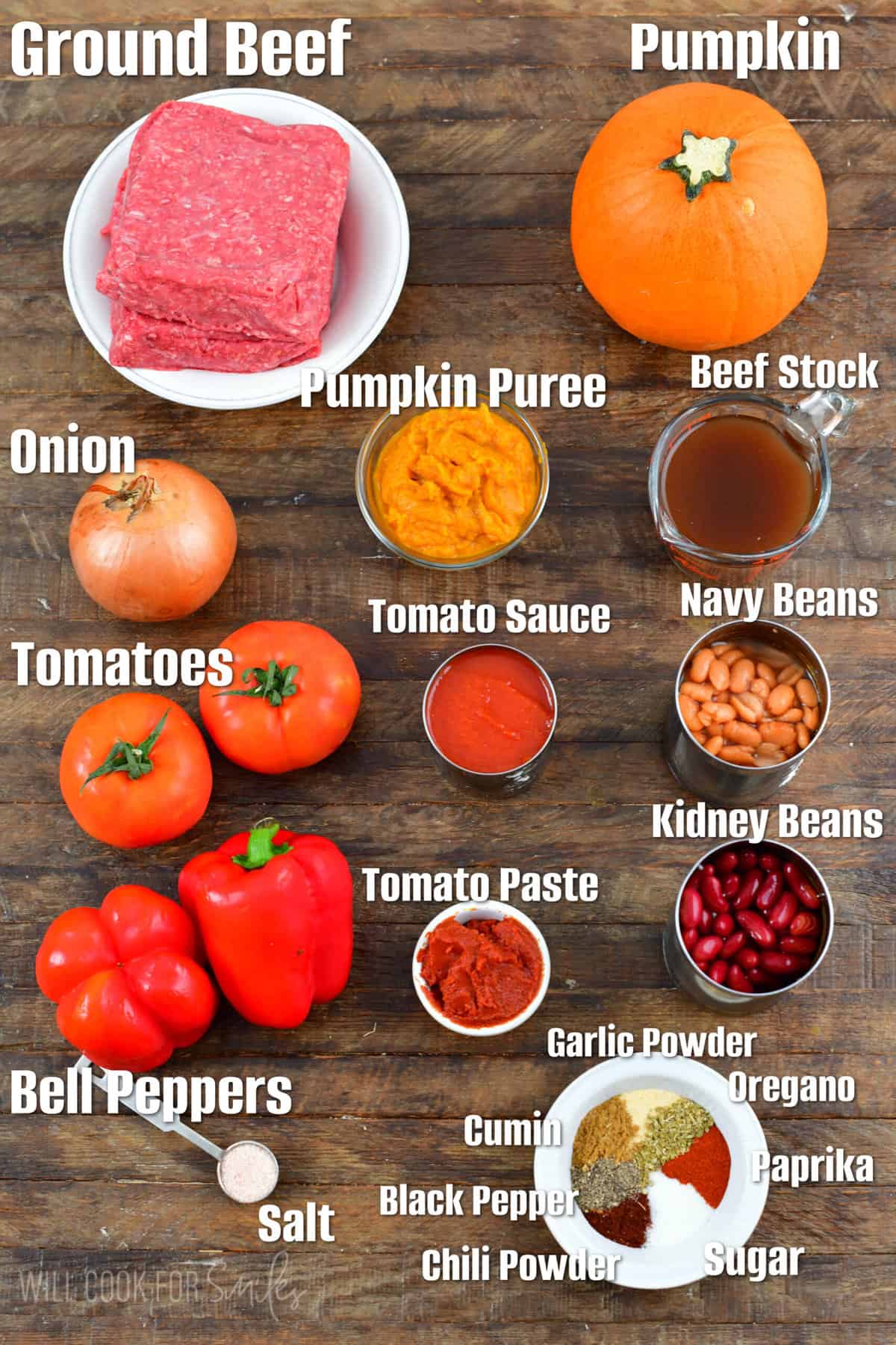 Labeled pumpkin chili ingredients on a wood surface.