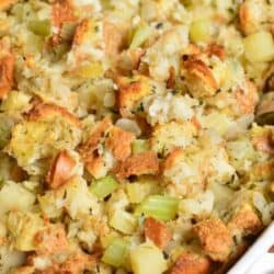 Stuffing in a baking pan on a wood surface.