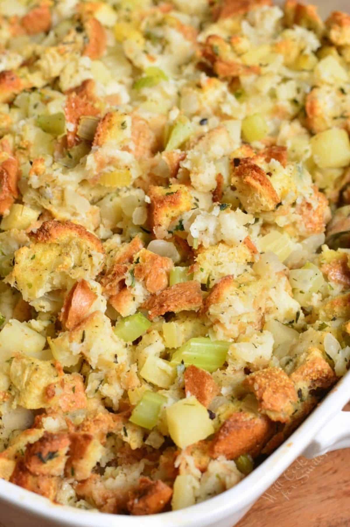 Stuffing in a baking pan on a wood surface.