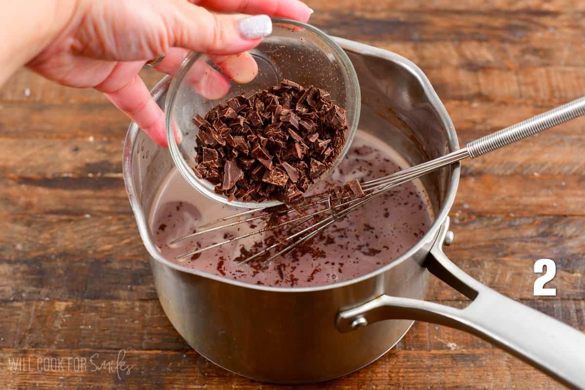 adding chopped chocolate to the pot.