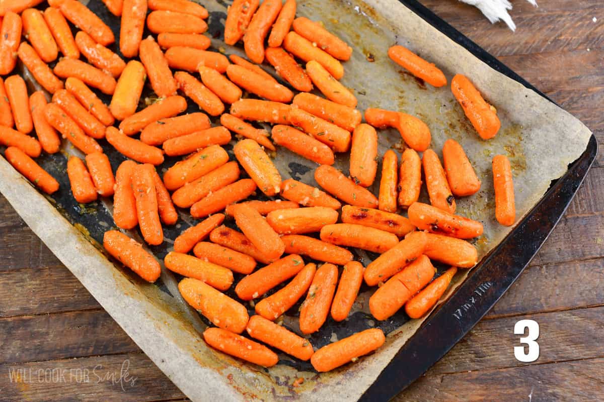 roasted carrots on the parchment paper covered baking sheet.