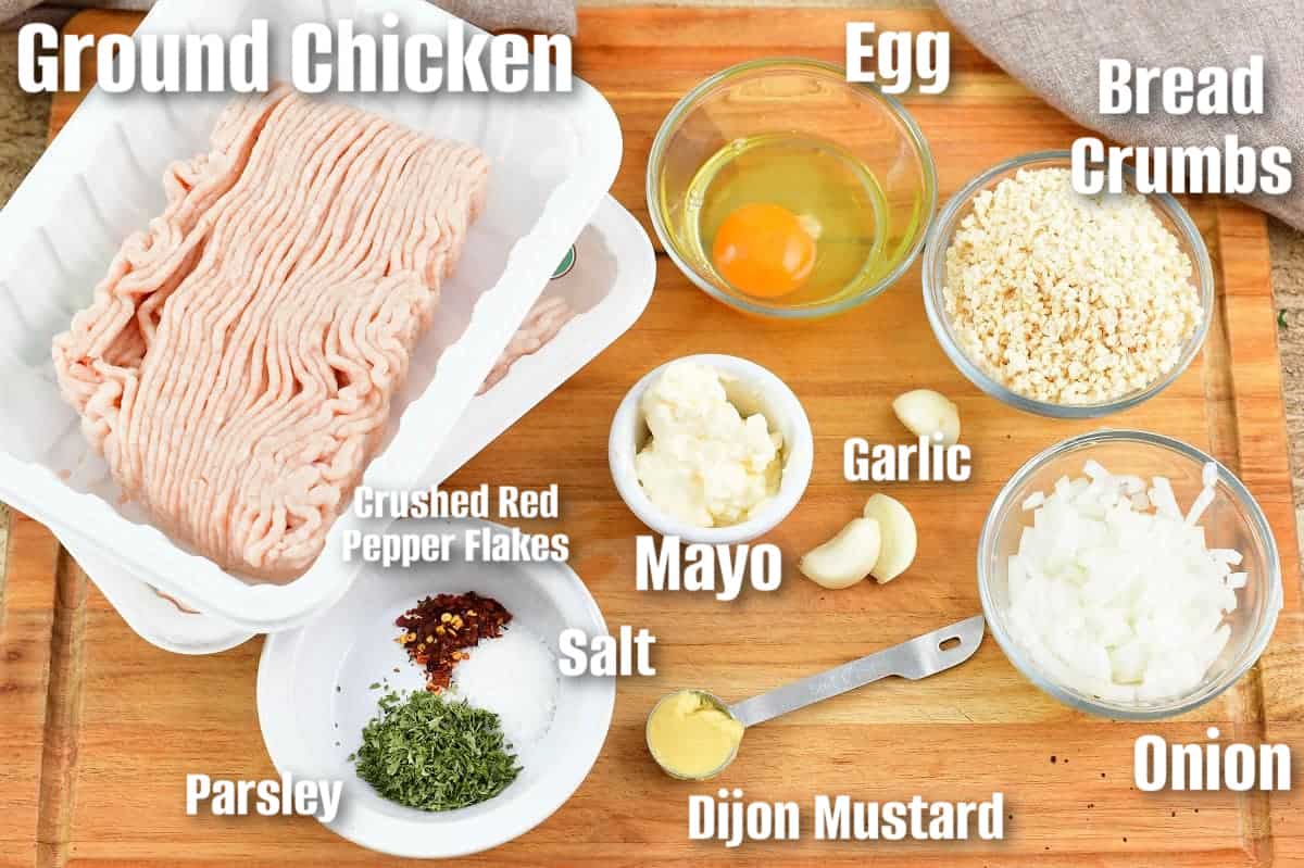 labeled ingredients to make chicken meatballs on the cutting board.