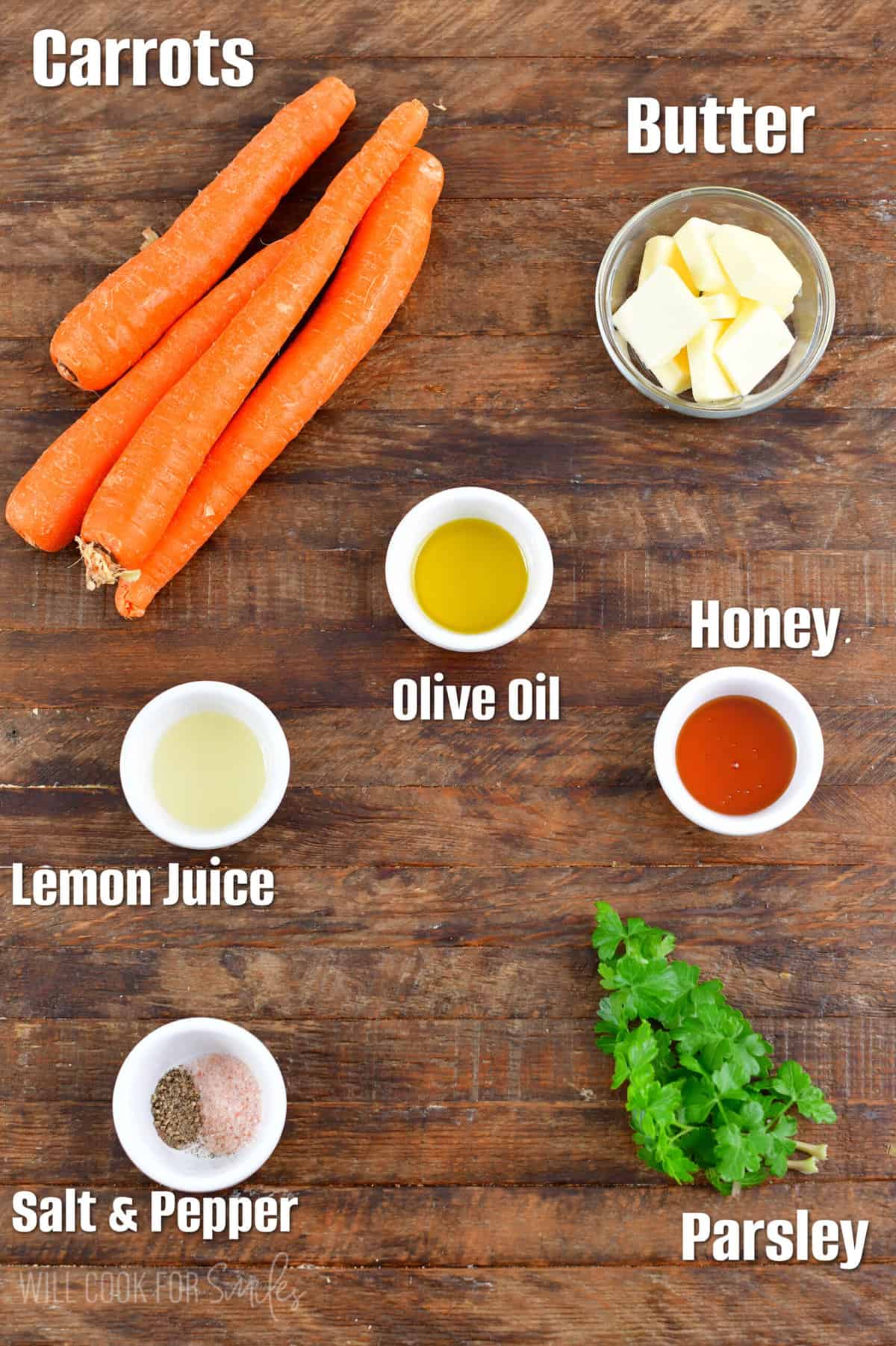 labeled ingredients to make honey glazed carrots on wooden board.