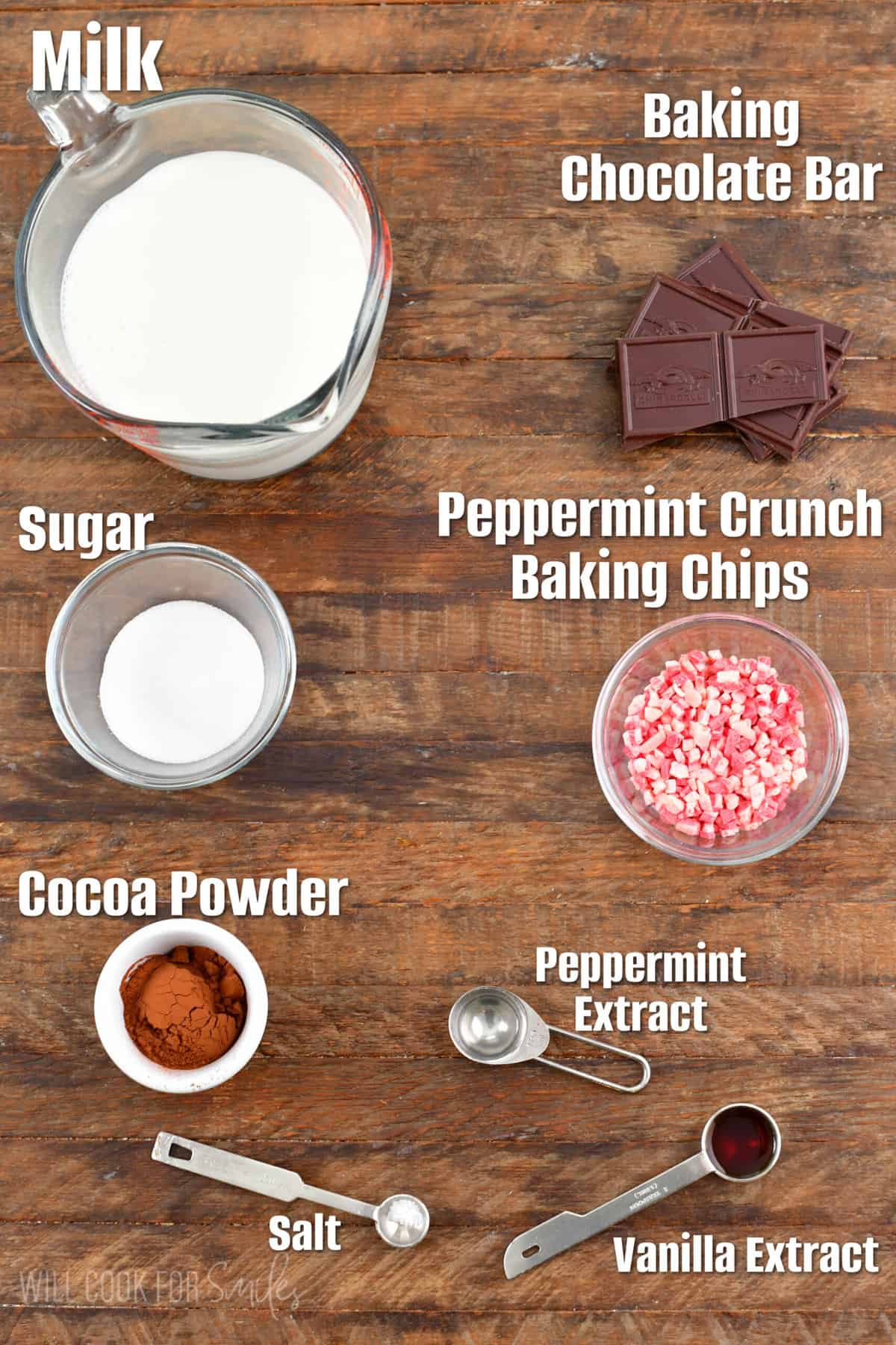 labeled ingredients to make peppermint hot chocolate on a wooden board.
