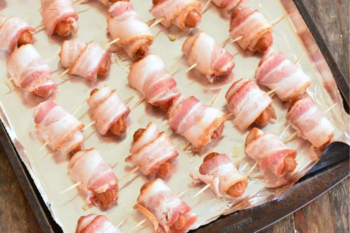 several little sausages wrapped in bacon and fastened with a toothpick.