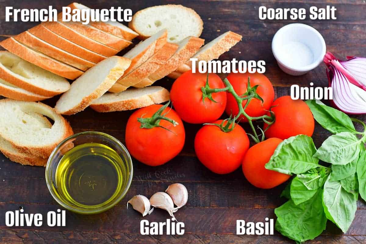 labeled ingredients to make bruschetta on a wooden surface.