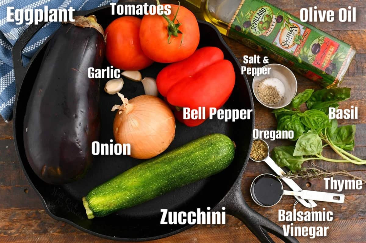 labeled ingredients to make ratatouille in a skillet and on wooden board.