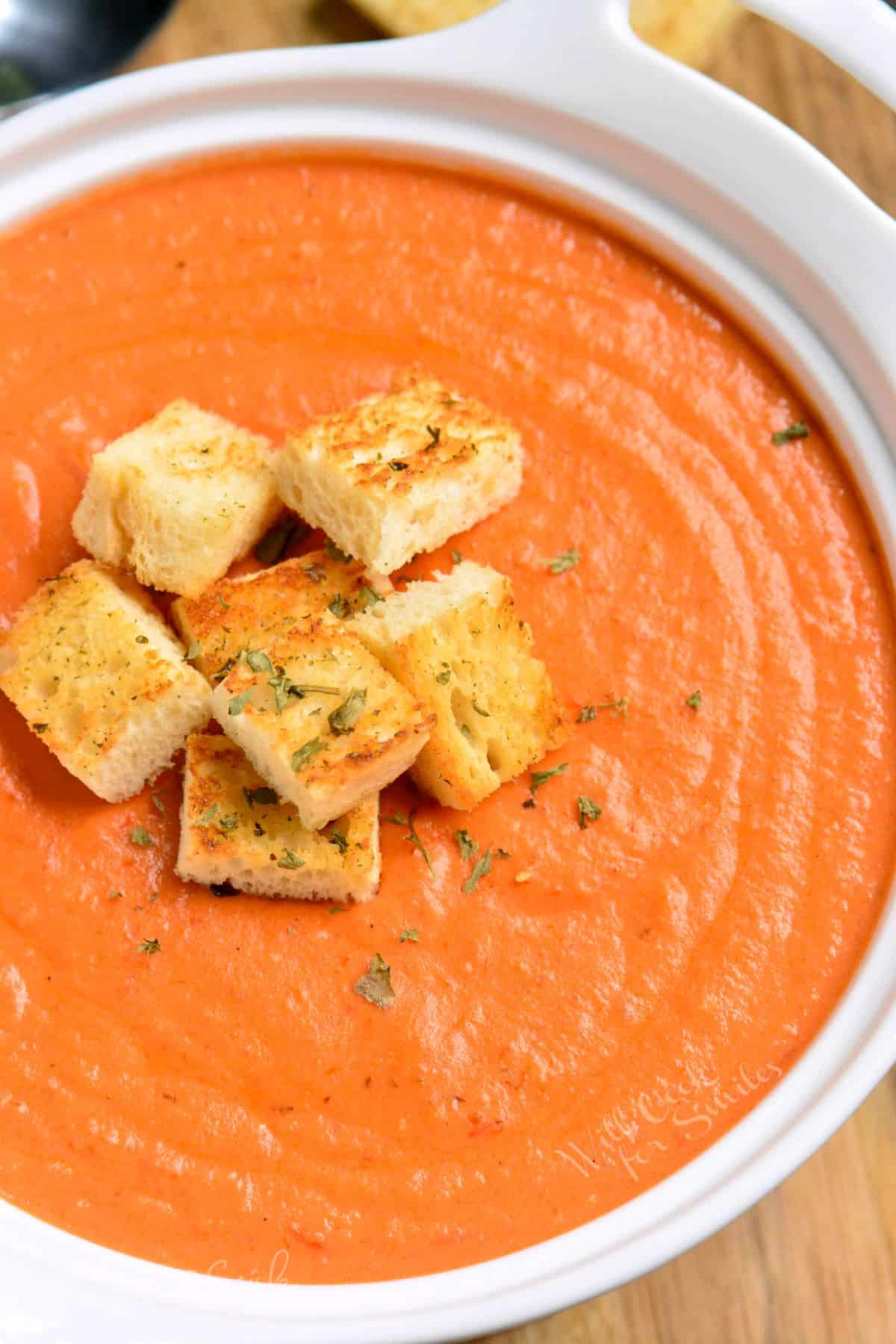 tomato bisque in a bowl with homemade croutons.