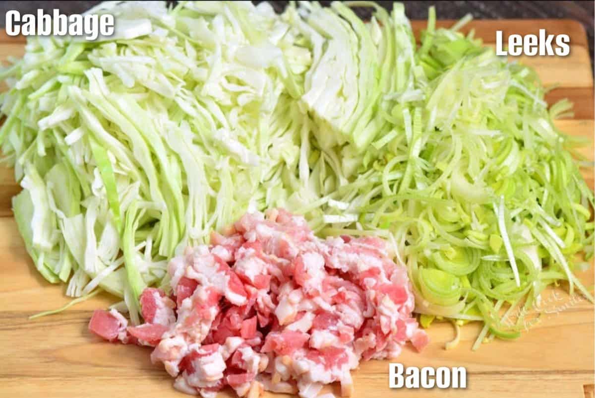 Labeled ingredients for fried cabbage on a wood surface.