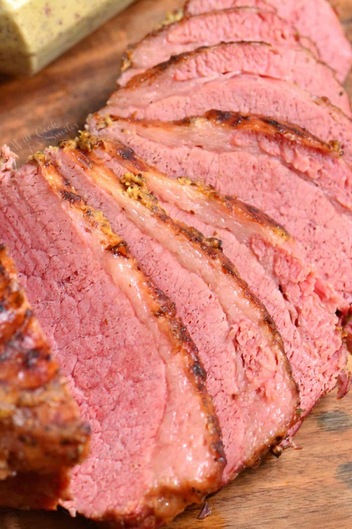 Instant pot corned beef on a wood cutting board.