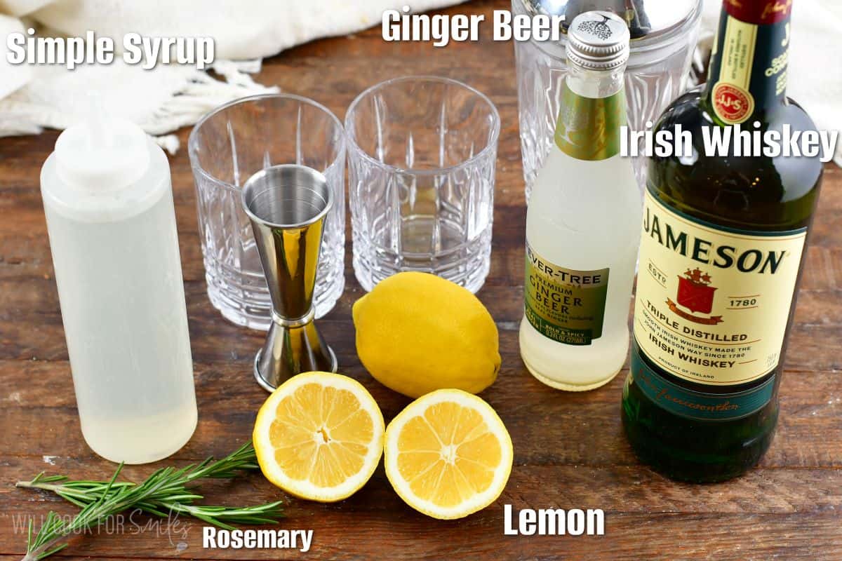 Labeled ingredients for Irish Lemonade on a wood surface.