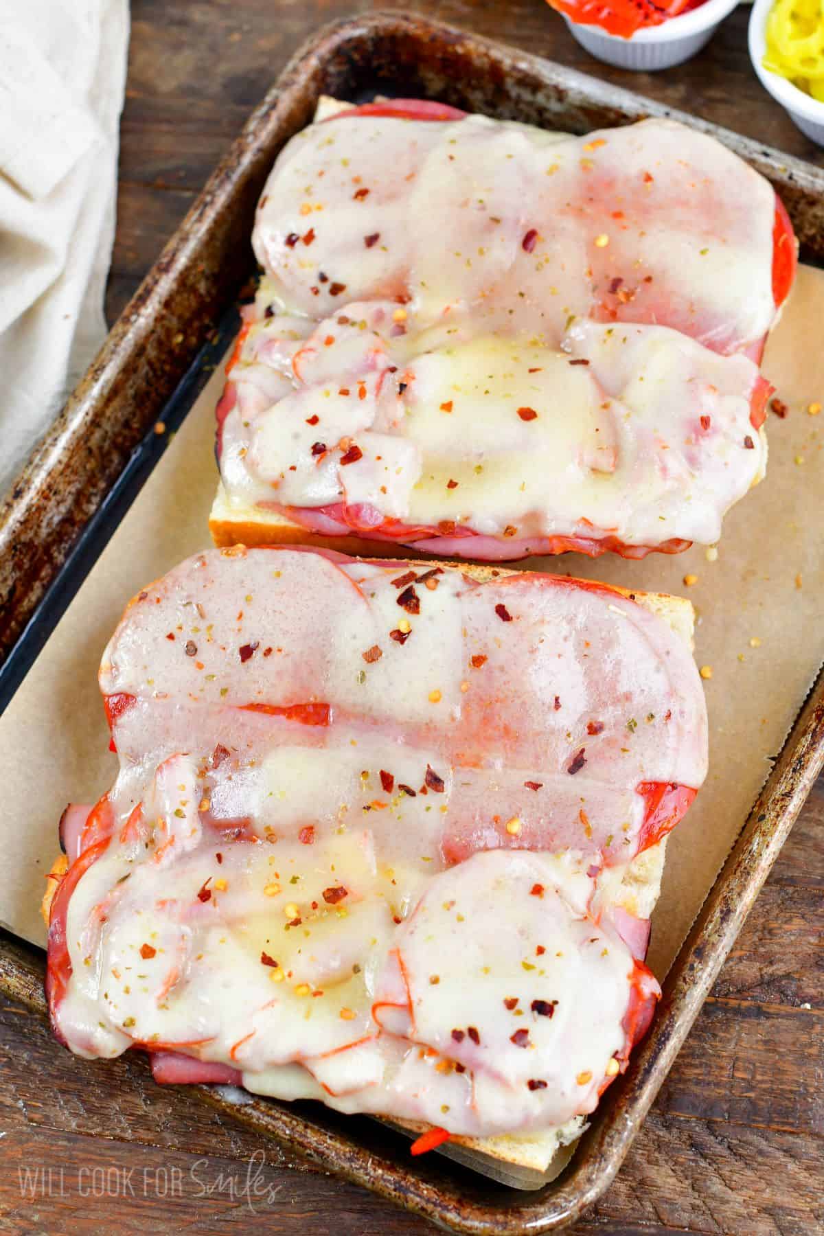 Open Italian Sub after baking on a baking sheet lined with parchment paper.