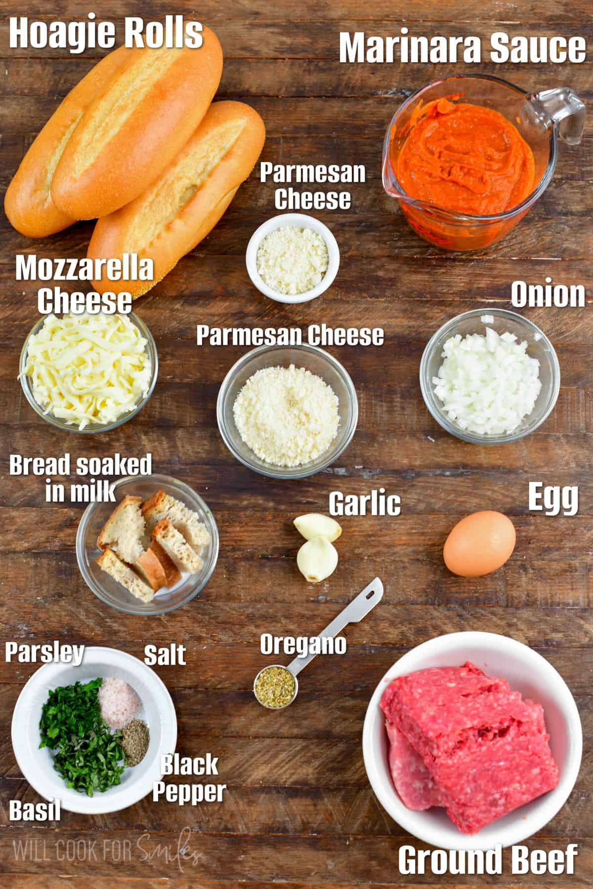 Labeled ingredients for meatball subs on a wood surface.