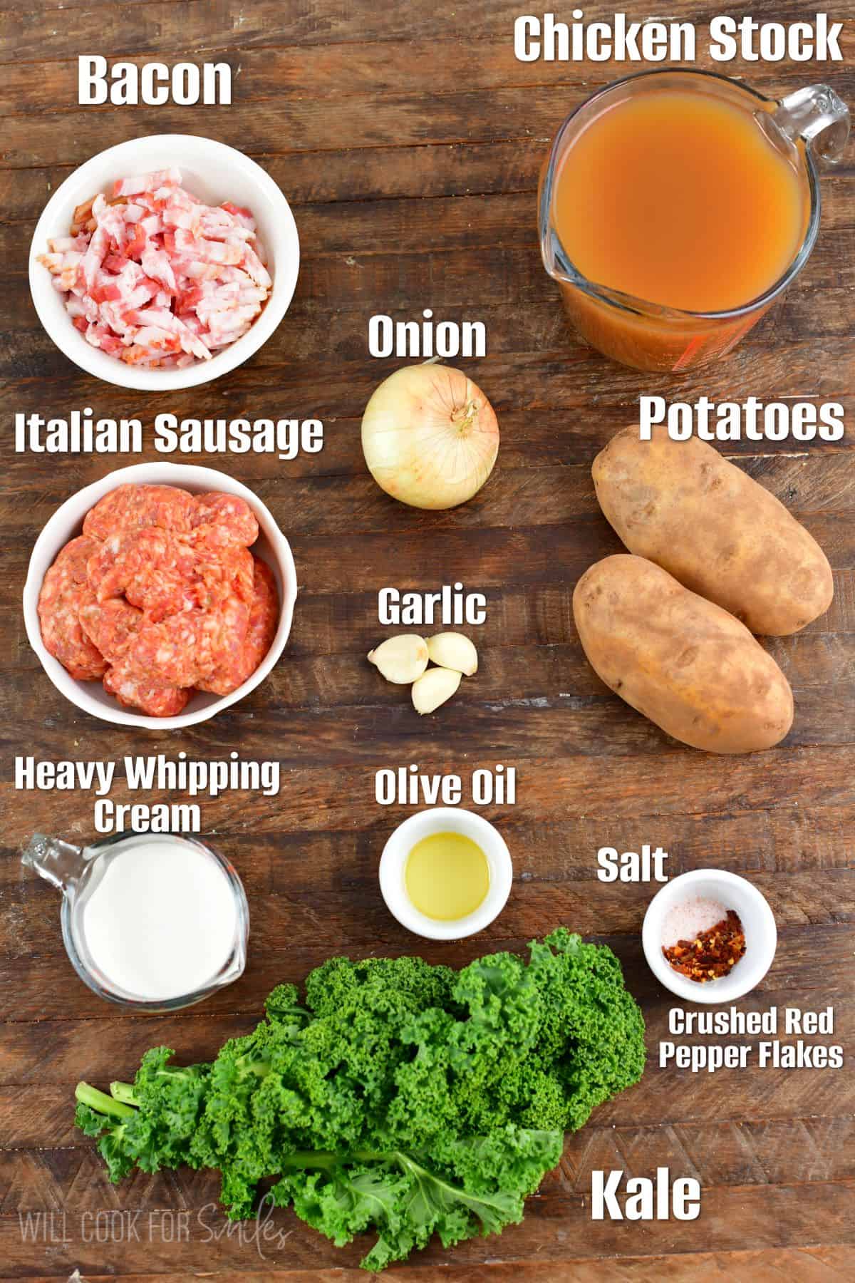 Labeled ingredients for Zuppa Toscana soup on a wood surface.