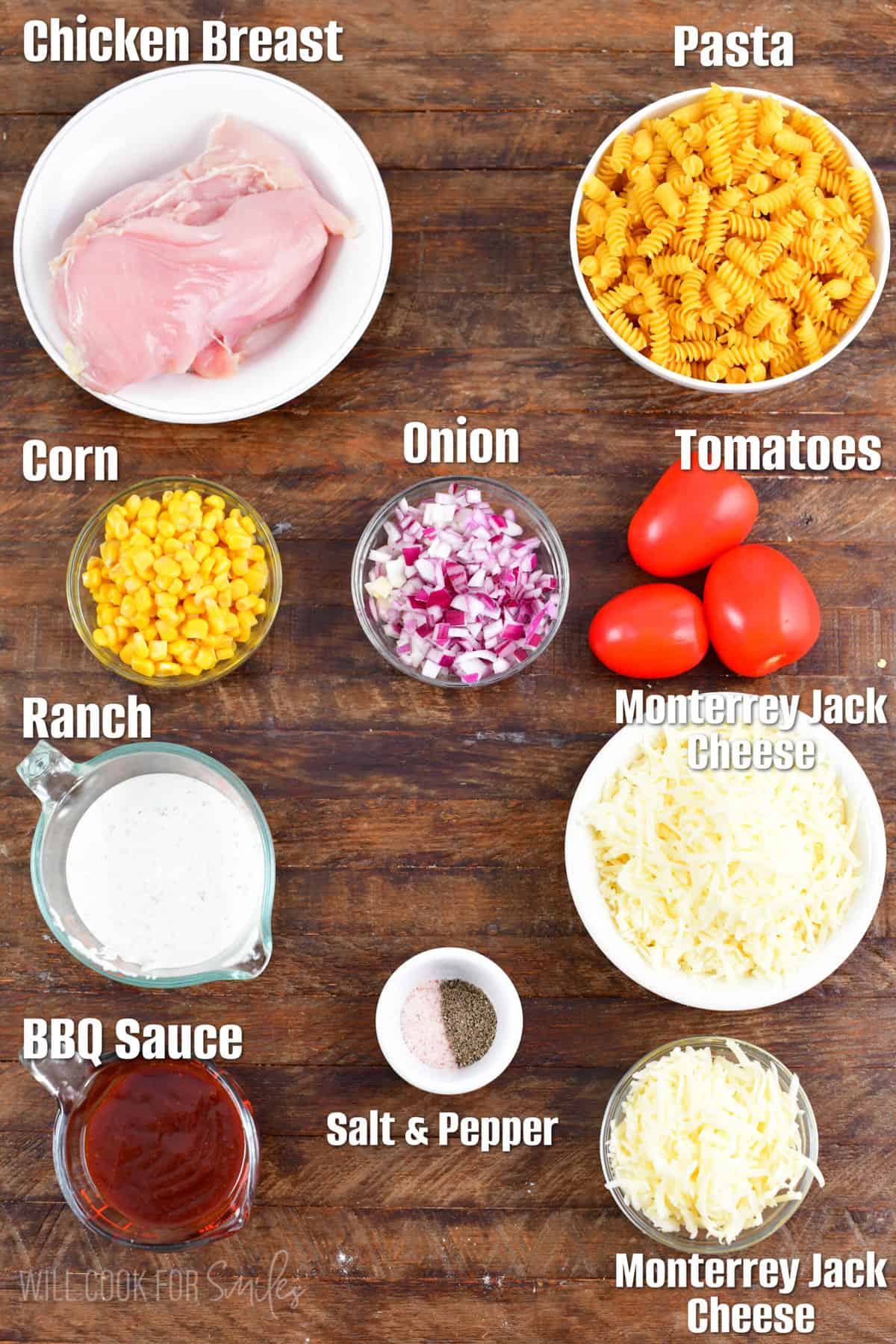Labeled ingredients for BBQ ranch chicken pasta bake on a wood surface.