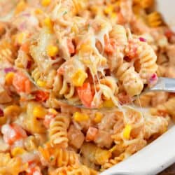 BBBQ ranch chicken pasta bake scooped out on a spoon and the rest in a casserole dish,