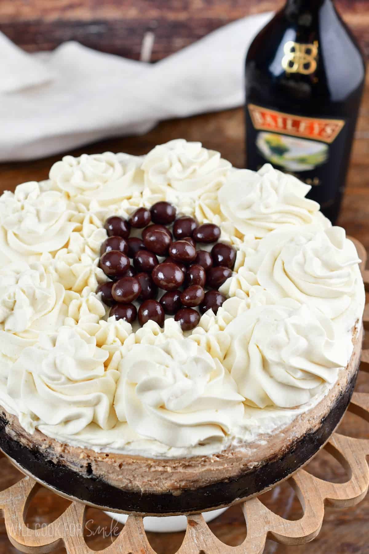 Whole Bailey's cheesecake topped with Bailey's whipped cream and chocolate beans.
