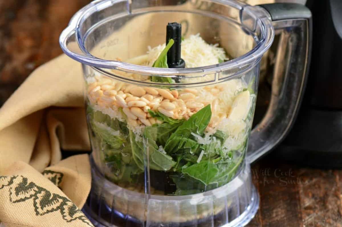 ingredients for pesto packed in the blender before blending.