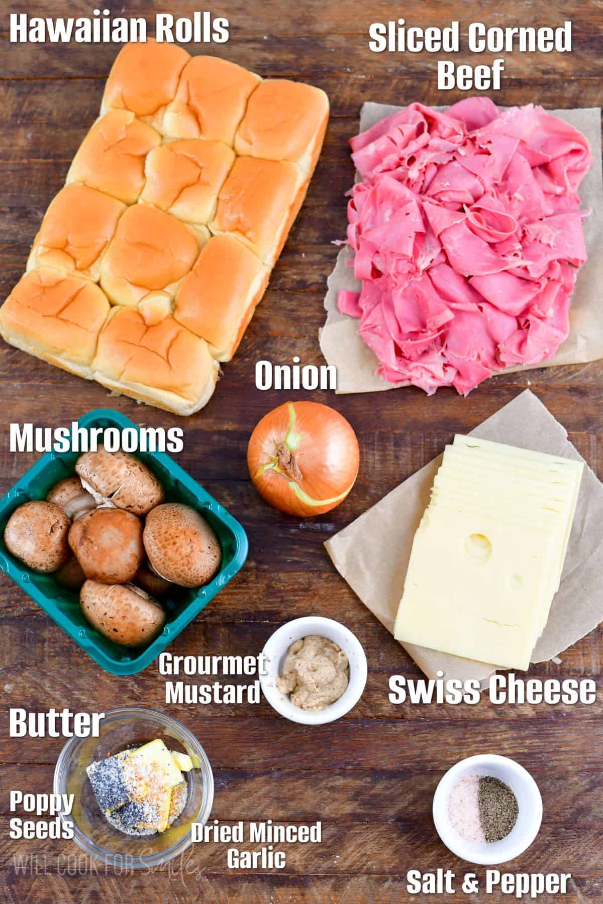 Labeled ingredients for corned beef sliders on a wood surface.