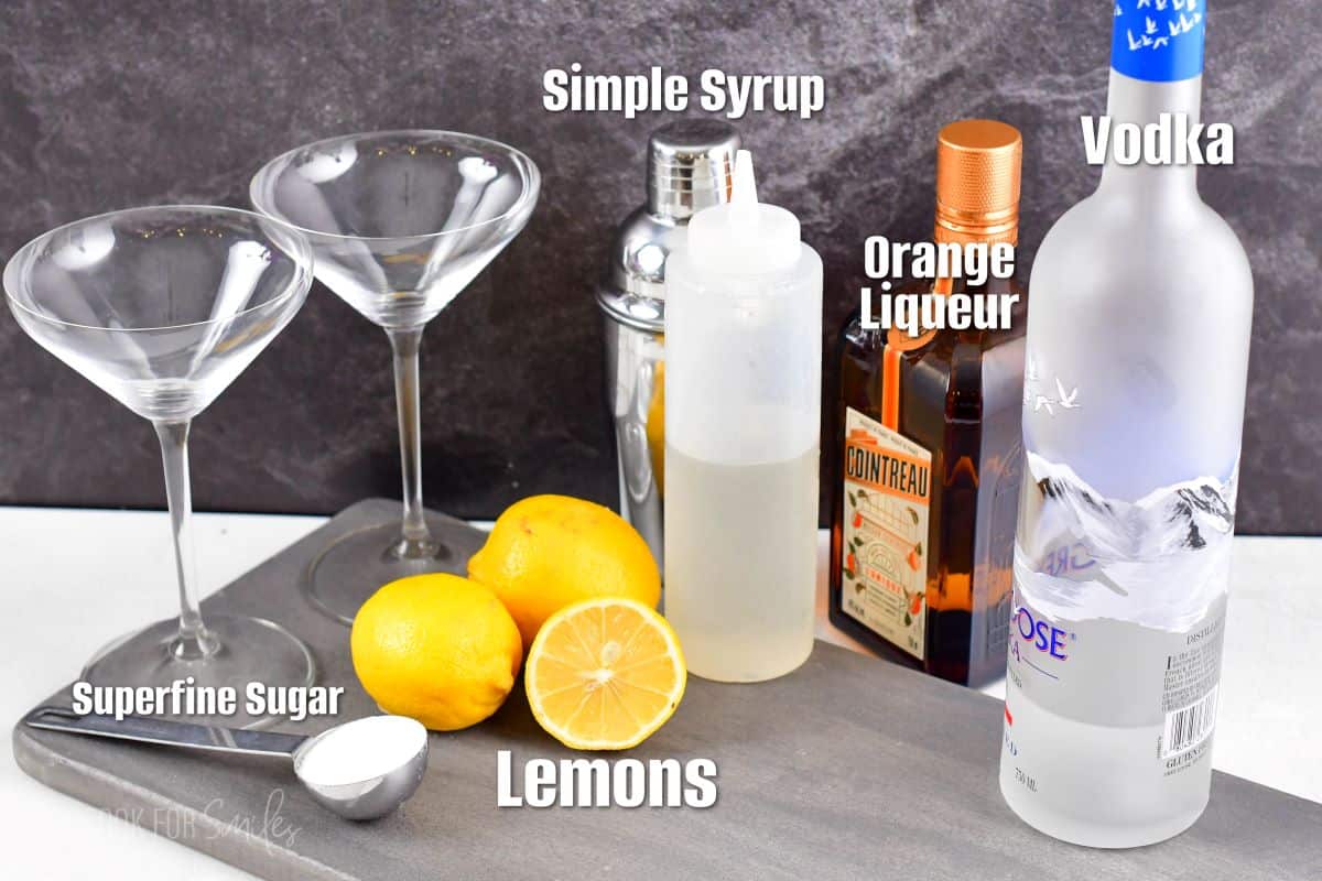 Ingredients for lemon drop martini on a gray piece of wood.