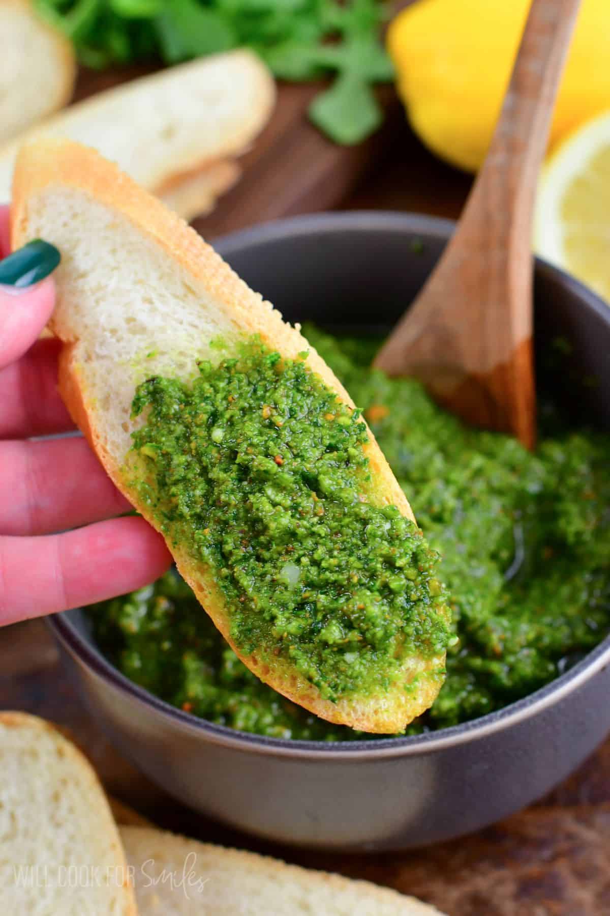 Lemon Pistachio Arugula Pesto spread on a slice of bread.