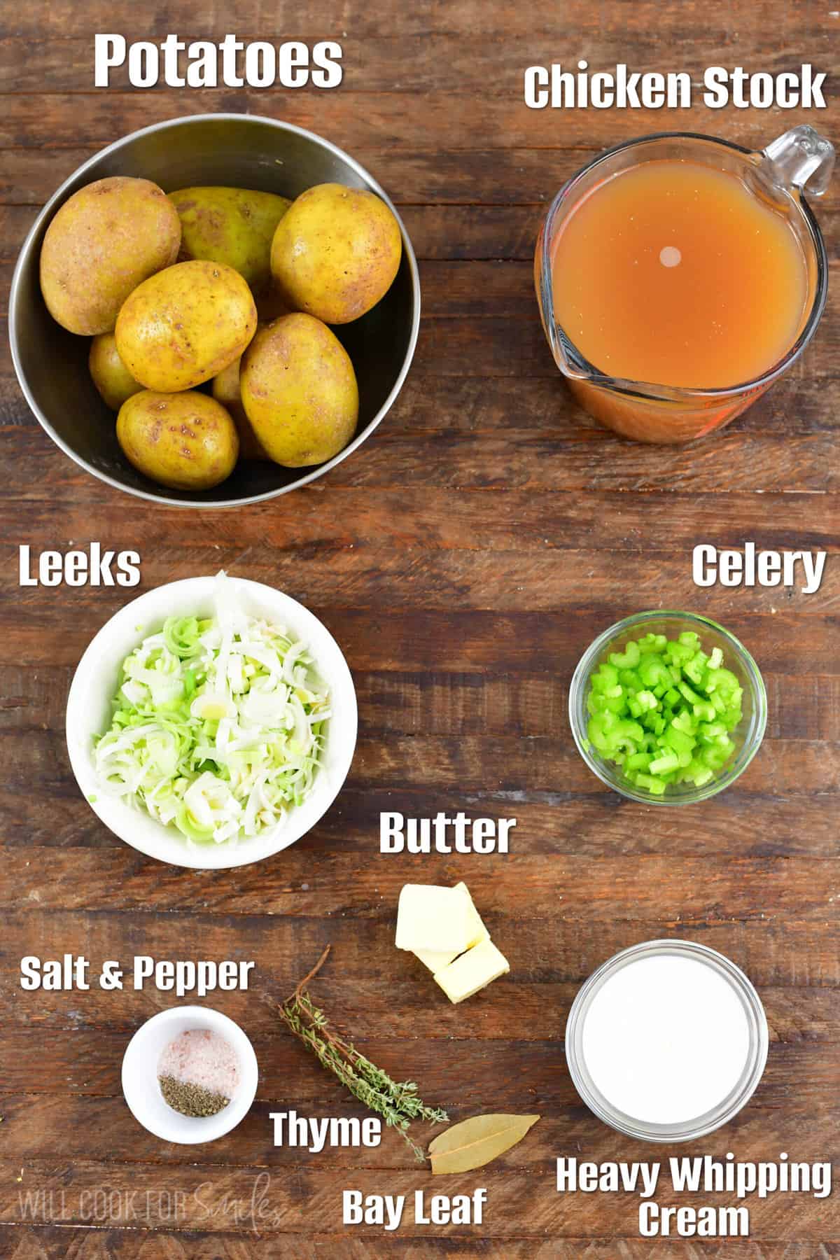 Ingredients for potato leek soup on a wood surface.