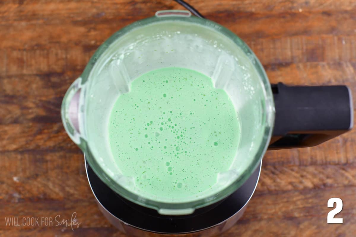 Ice cream and green food coloring mixed up in a blender.