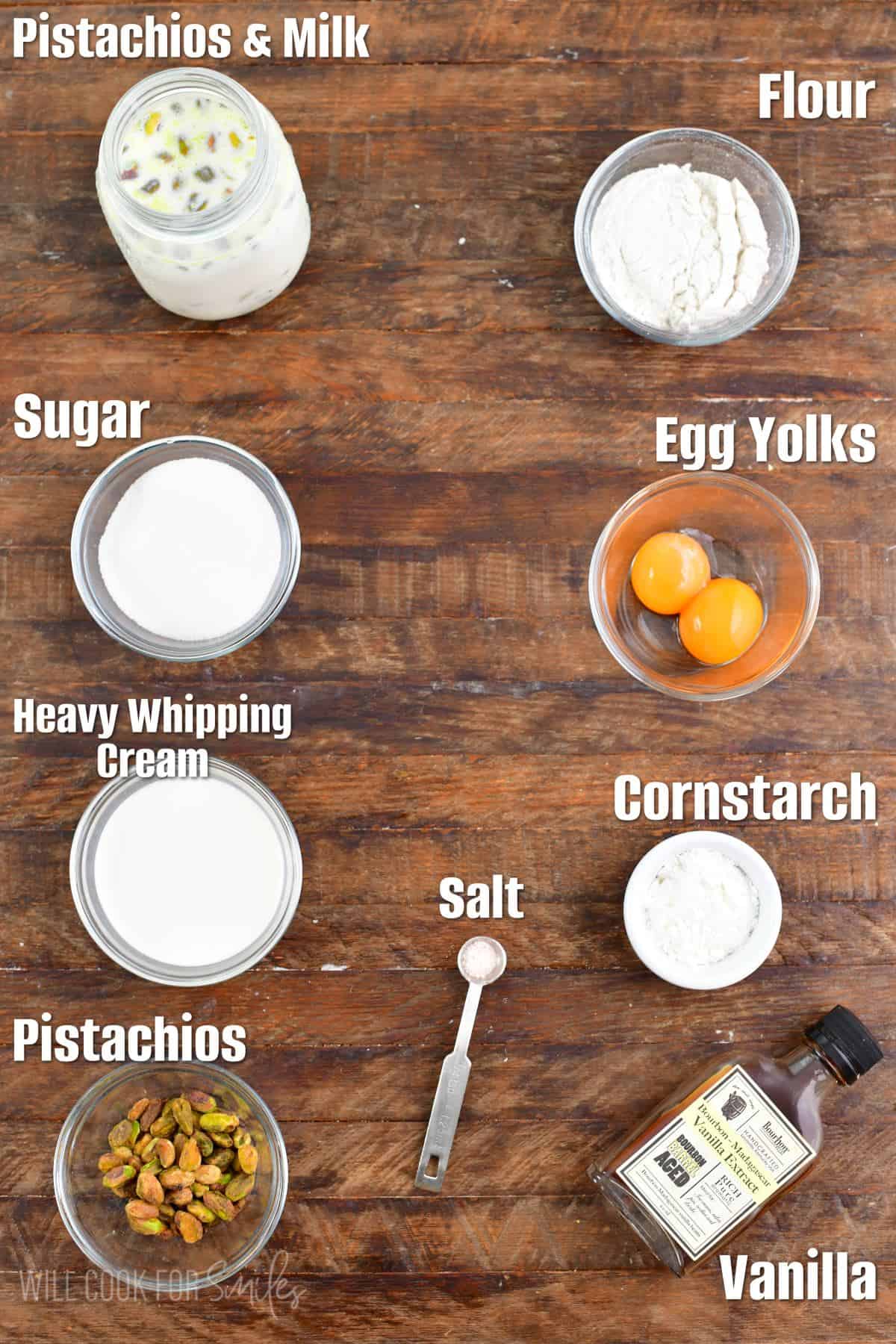 labeled ingredients for pistachio pudding on a wood surface.