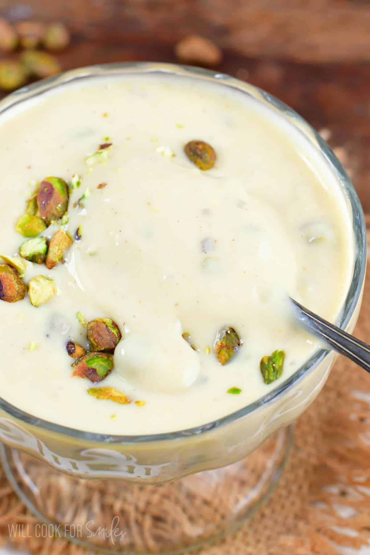 pistachio pudding in a bowl and a spoon starting to scoop some out.