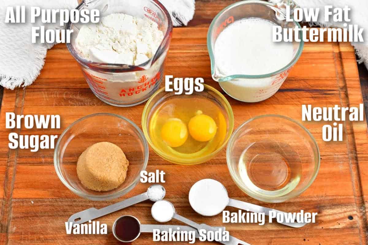 labeled ingredients for make buttermilk pancakes are spread out on a wooden surface.