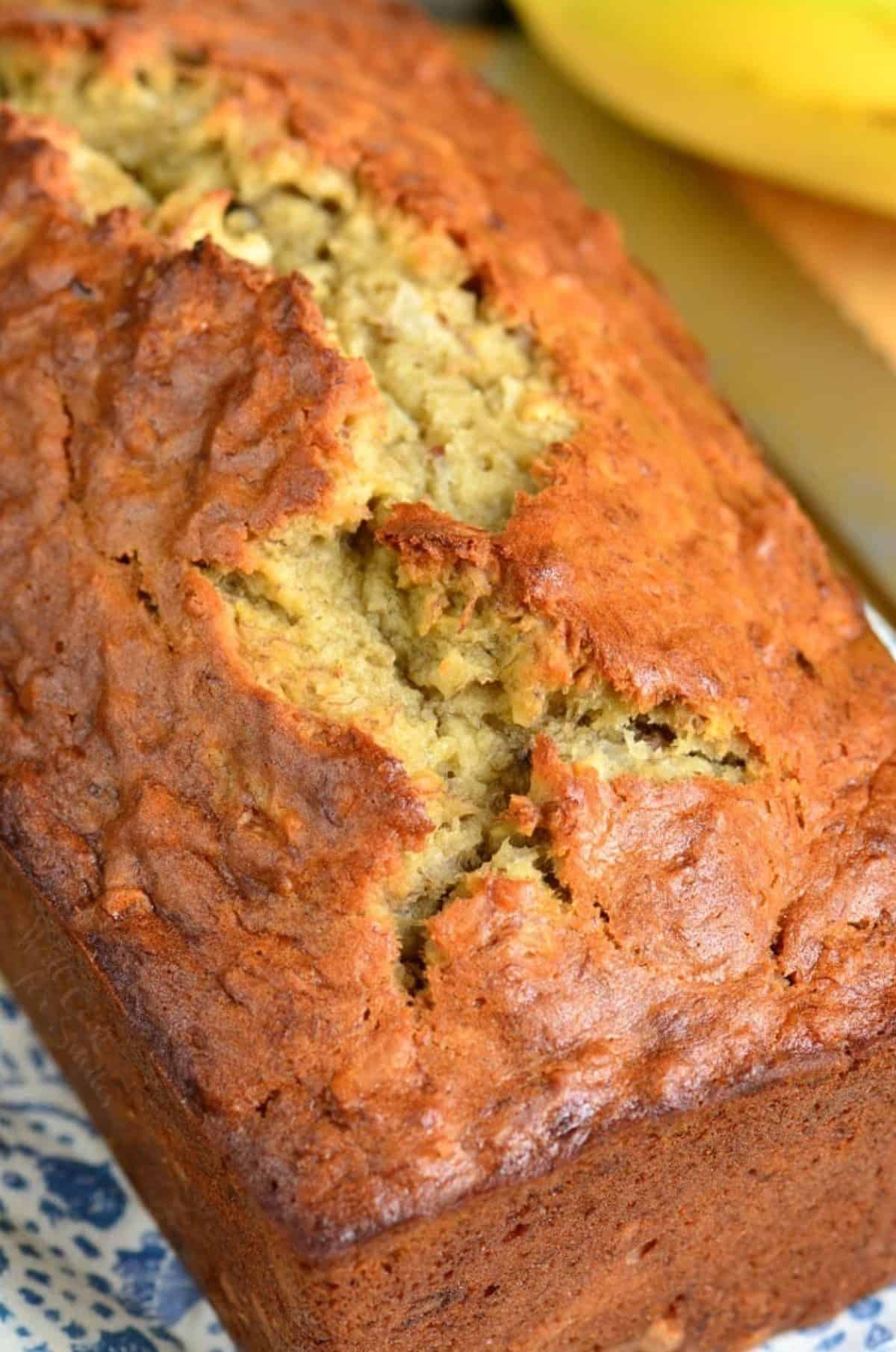 Coconut banana bread out of the pan and on a plate.