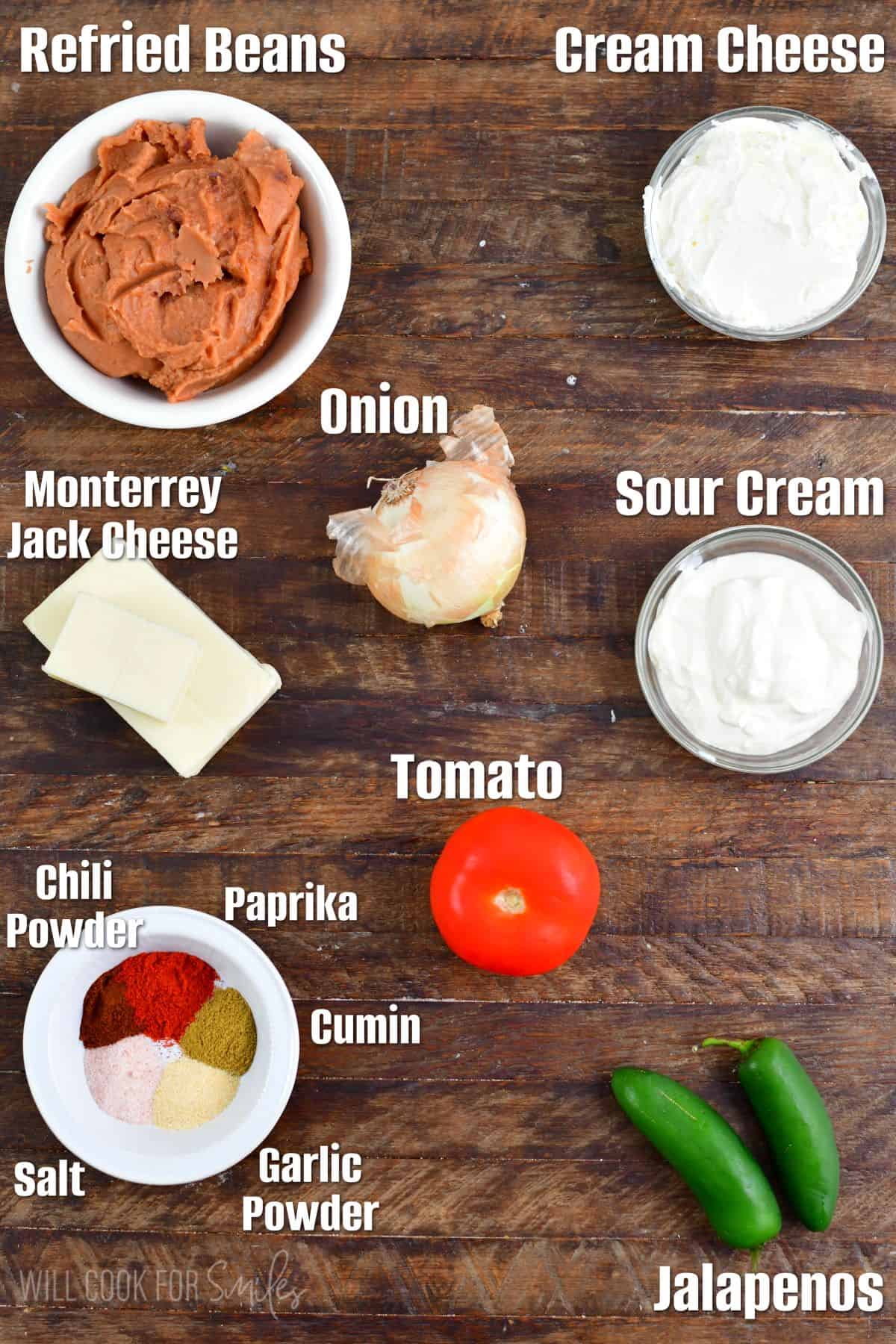 labeled ingredients to make the hot bean dip on the wooden background.