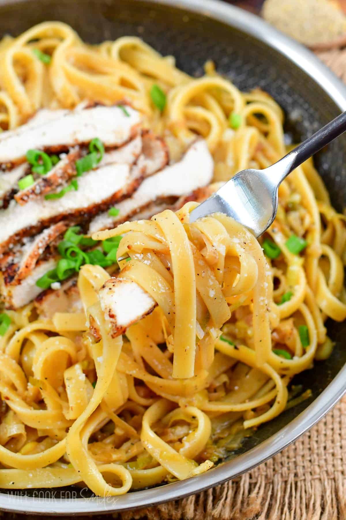 Lemon pepper chicken pasta with pasta swirled onto a fork.